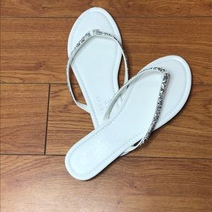 White flip flops with silver sparkly straps